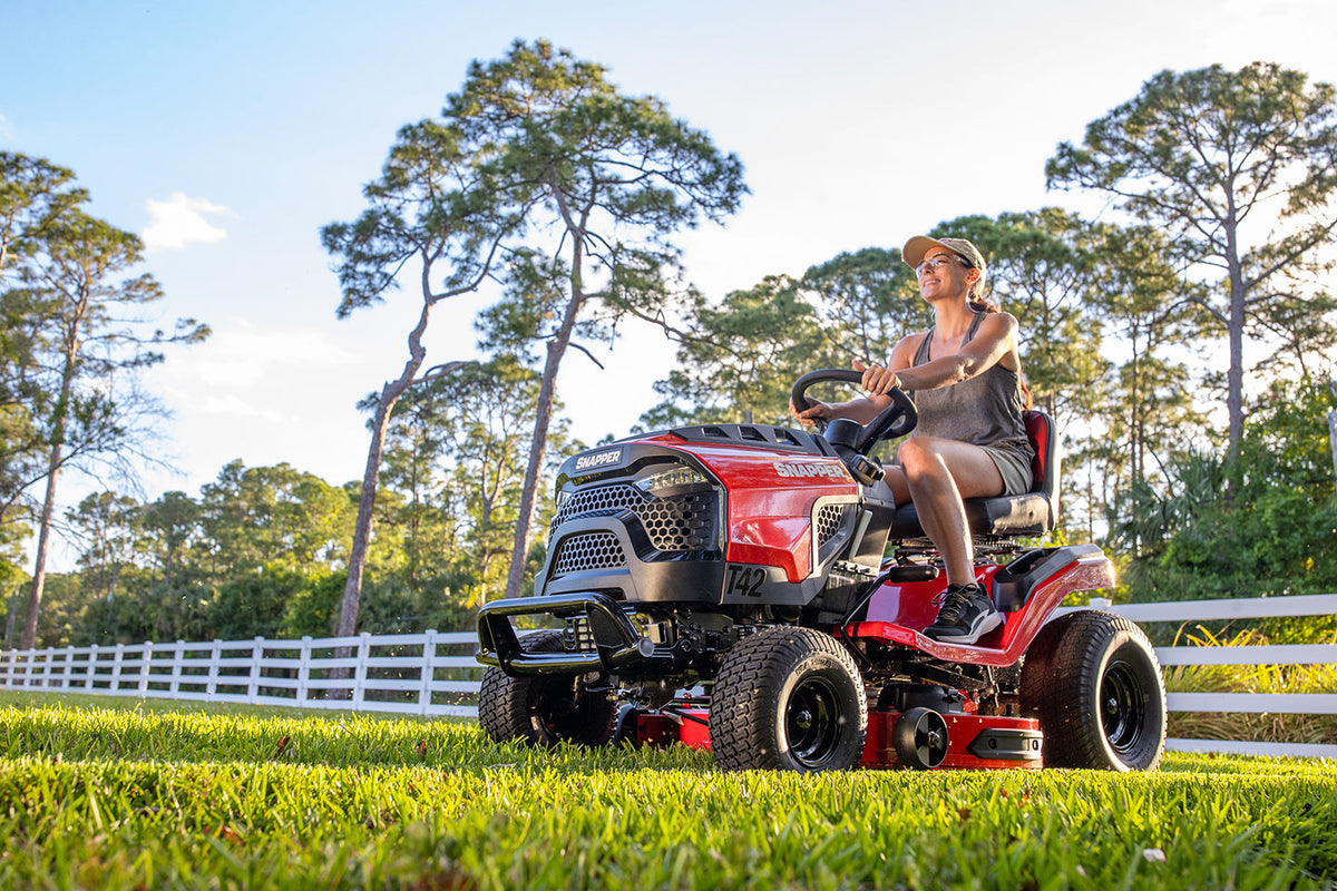 Snapper T42 42-inch riding lawn tractor mowing thick residential lawn.